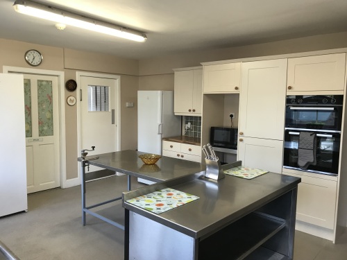 The kitchen has plenty of preparation space and a range of cooking equipment