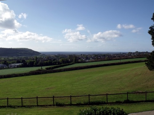 The view from Peacehaven overlooking Seaton and the Axe Valley to the sea.