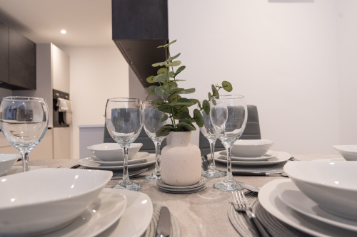 Dining table set for shared meals, perfect for relaxing dinners after a day exploring Folkestone