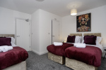 Spacious ensuite bedroom with two zip-link king beds and a single bed