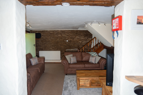 Character-filled interiors combine exposed stone walls, comfortable seating and modern conveniences for a relaxing stay.