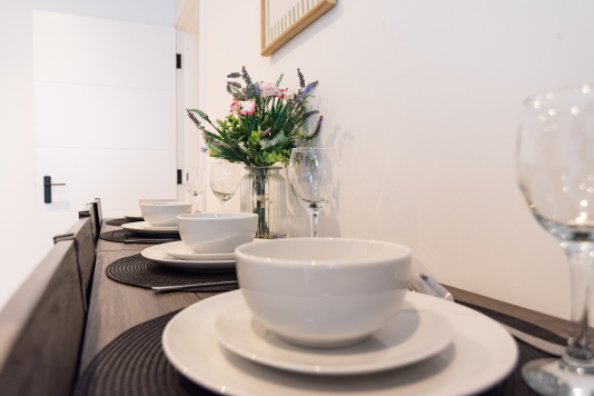 Table set and ready for shared meals during your stay.
