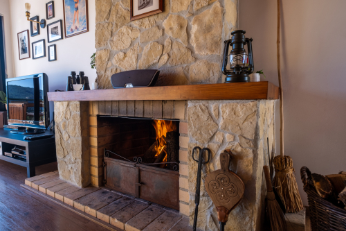 Rustic open fireplace decorated with stones from the river Zêzere.