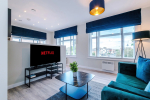 Spacious living room with comfortable seating and inviting atmosphere, perfect for relaxing or socialising during your stay.