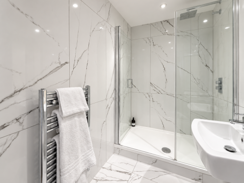 Walk-in shower
Stylish walk-in shower finished with elegant marble-effect tiles, a rainfall shower and polished chrome fittings for a luxurious, hotel-inspired feel.