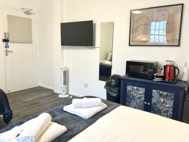 In each room: Microwave, plates, bowls, cutlery, tea, coffee, sugar, biscuits, kettle, mugs, drinking glasses