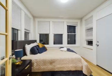 Surrounded by wall-to-wall windows, this bedroom is bathed in natural light by day and offers a serene view of the night sky. Sink into the plush bedding with velvet accents and let the city fade away. A cozy haven where luxury meets relaxation.