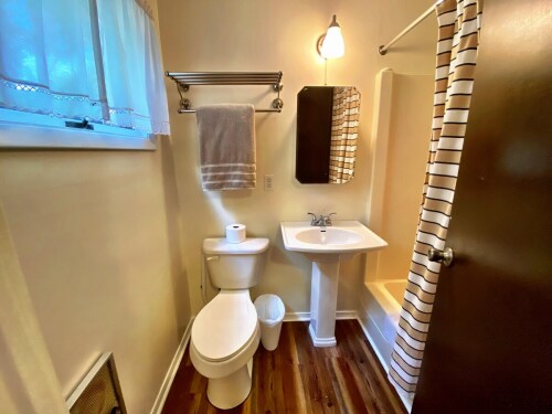 Bathroom with tub/shower, window for natural light.  
