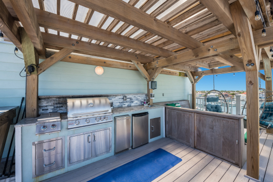 Rooftop kitchen has ice maker, refrigerator, sink