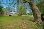 Cedar cottage, relax under willow tree by the woodland setting.  View of garden office.  