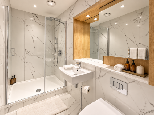 Walk-in shower
Stylish walk-in shower finished with elegant marble-effect tiles, a rainfall shower and polished chrome fittings for a luxurious, hotel-inspired feel.