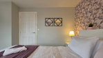 A bedroom fit for a master of relaxation. Plenty of storage, a peaceful ambiance, and the bathroom just next door.