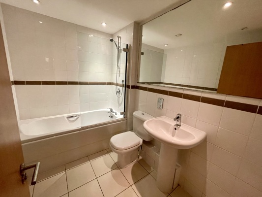 Family bathroom with shower over bath