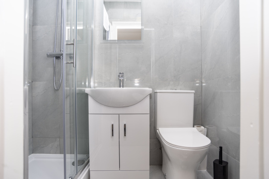 Private en suite fully stocked with hand wash, shower gel, shampoo and conditioner — a clean, convenient space offering comfort and complete privacy throughout your stay.