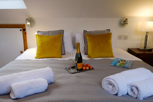 The large upper bedroom has a Super King double bed and also a single bed. The Super King bed can also be configured as two full-size single beds if required, giving guests the option of three single beds in this room.