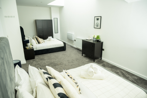 Sleep easy in this spacious double bedroom with soft linens and a relaxing ambience.
