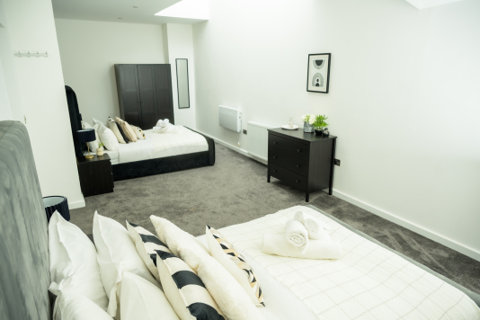 Sleep easy in this spacious double bedroom with soft linens and a relaxing ambience.