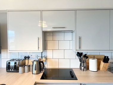 stove and cupboards stocked with all crockery + glassware