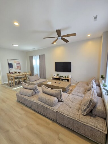 Relax in this elegant living space featuring a plush sectional sofa, a 55