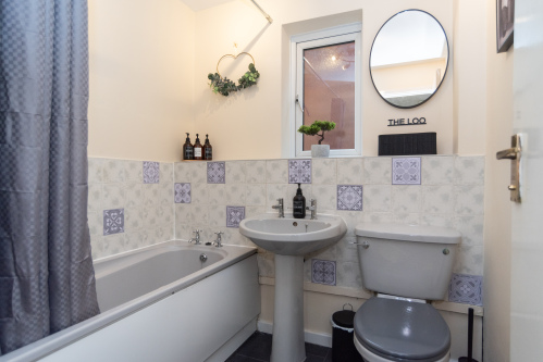 A spacious master bathroom with bath and shower, toilet and complimentary toiletries, plus fresh towels provided for a comfortable short or longer-term stay.