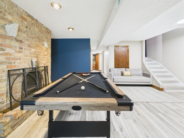 A game lounge that blends vintage brick with playful sophistication.