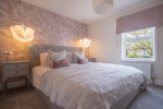 Experience elevated living with this beautifully appointed master bedroom.