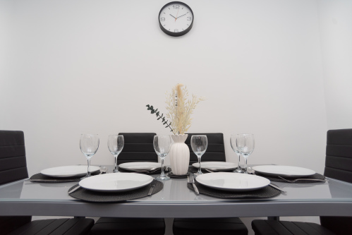 Dining table fully equipped for meals, with plates, cutlery and everything you’ll need for a comfortable, home-from-home stay.