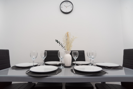 Dining table fully equipped for meals, with plates, cutlery and everything you’ll need for a comfortable, home-from-home stay.