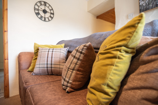 Sink into comfortable sofas and enjoy a peaceful evening in this welcoming countryside cottage.