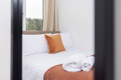 Private single bedroom offering a quiet, comfortable space — perfect for guests needing privacy and a restful stay.