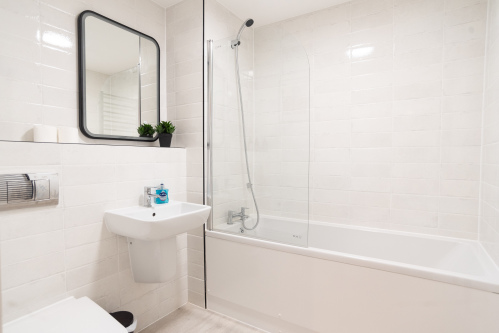 Modern master bathroom with bath, shower and complimentary toiletries.