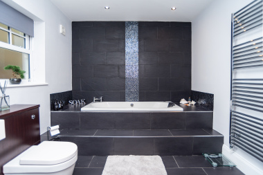 Master bathroom with a walk-in whirlpool bath, sleek modern finishes, and complimentary shampoo, conditioner, shower gel, and plenty of fresh towels for your stay.