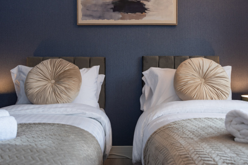 Two beautifully styled twin beds designed for a restful night’s sleep — the perfect space to unwind and feel at home.