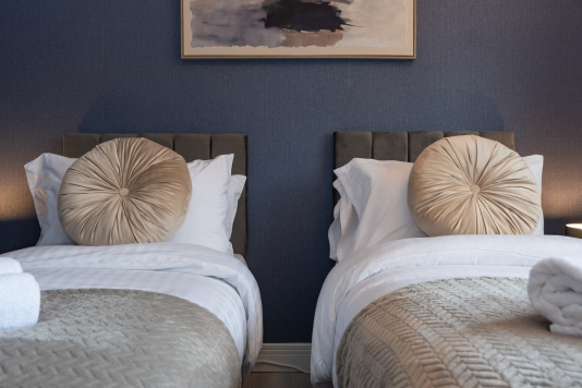 Two beautifully styled twin beds designed for a restful night’s sleep — the perfect space to unwind and feel at home.