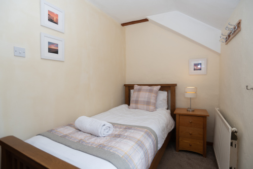 Wake up to peaceful countryside views from the bright single bedroom overlooking the cottage grounds.