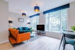 A spacious living room equipped with a large TV and comfortable sofas, perfect for relaxing and unwinding after a day of exploring.