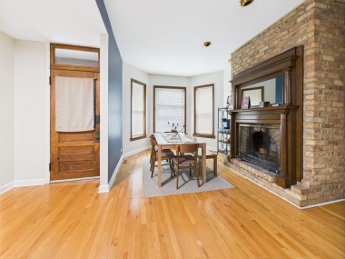 An elegant dining corner anchored by a vintage fireplace.
