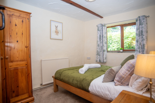 Wake up to peaceful countryside surroundings in the inviting master bedroom, complete with a comfortable double bed, soft linens and