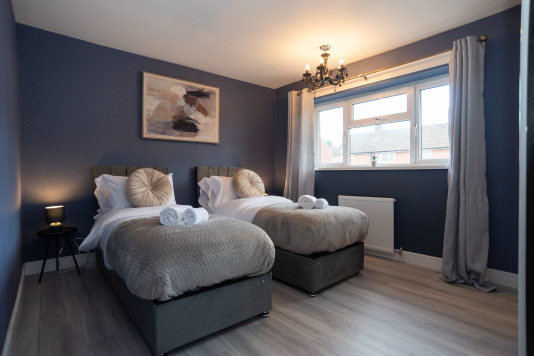 Spacious bedroom with a versatile setup — choose a comfy king bed or two singles. Features large wardrobes for easy storage throughout your stay.