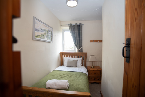 Cosy Single Bedroom - A compact, well-appointed room with hotel-quality linens, fresh towels and a warm bedside lamp, perfect for a solo traveller within your group.