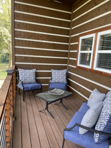 The Wyldwood Cabin has a wraparound porch with a living and dining area.