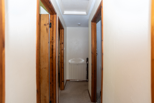 The cottage's traditional layout features a charming first-floor landing connecting the bedrooms and family bathroom.