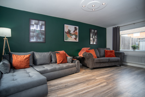 Spacious and welcoming living room with dual sofas, including a super-comfy double sofa bed with bedding ready to go. Enjoy the full HD Smart TV, cosy log burner, and soft ambient lighting - the perfect space to unwind.
