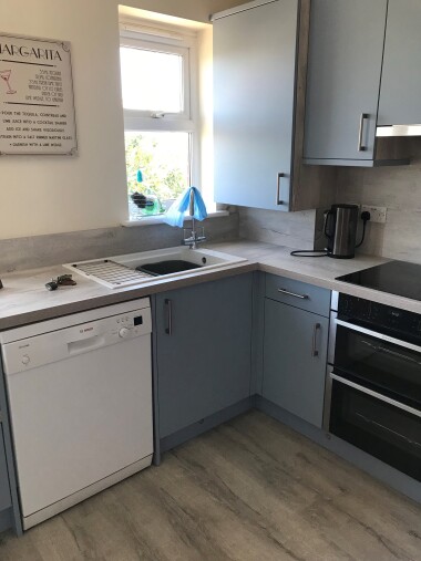 Kitchen with laundry appliances 