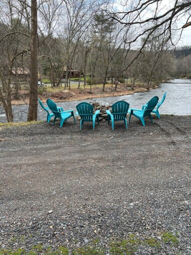 Creekside firepit steps away from the driveway of the home.