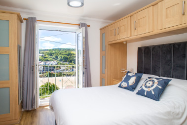 Bedroom 1 with balcony over looking beach