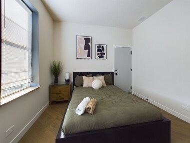 Retreat to this serene bedroom for restful nights and peaceful mornings. Sink into the plush bed, journal on the side table, or wake up to soft natural light streaming through the windows. This calming space invites relaxation and quiet reflection.
