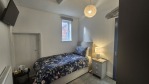 A well-appointed single bedroom within a spacious 7-bedroom property. With an en-suite shower, kettle, tea and coffee, wardrobe storage, and access to two kitchens, outdoor space, and high-speed Wi-Fi, it's ideal for corporate travellers, university affiliates, event attendees, and large groups alike.