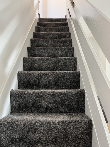 Stairs leading to 2 upstairs bedrooms and bathroom