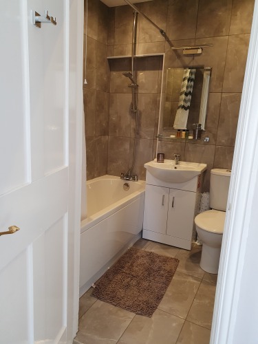 Wisteria Room. Family bathroom ensuite with heated towel rail and various shampoos provided.